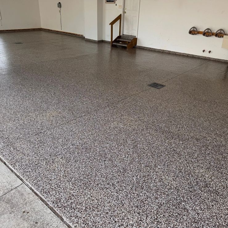 Decorative flake garage floor with stairs and a floor drain