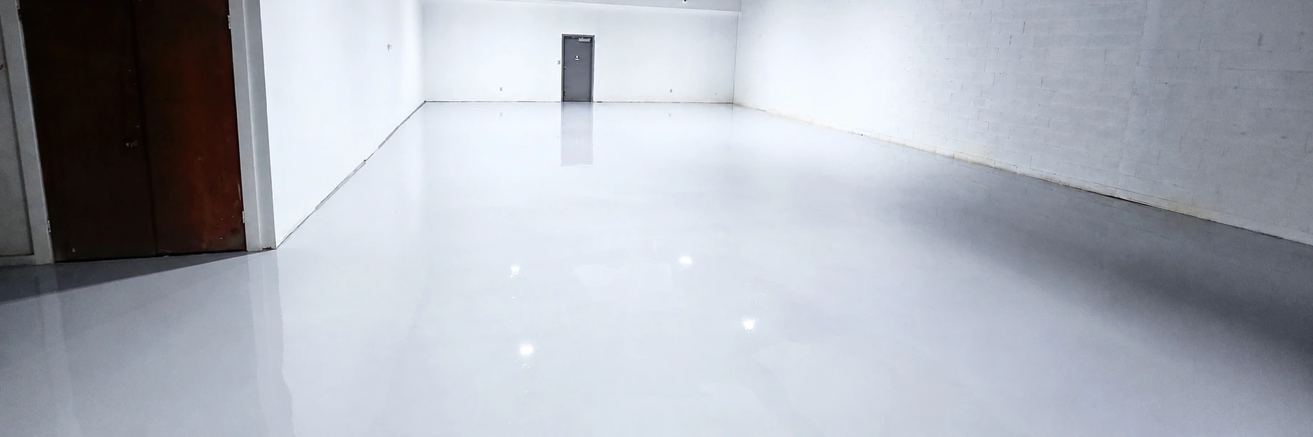 Glossy light-gray epoxy floor in a commercial space